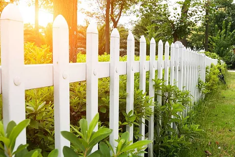White garden fence in greenery